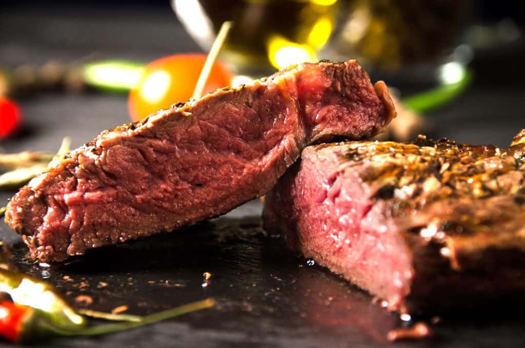 A steak sliced in half on a plate
